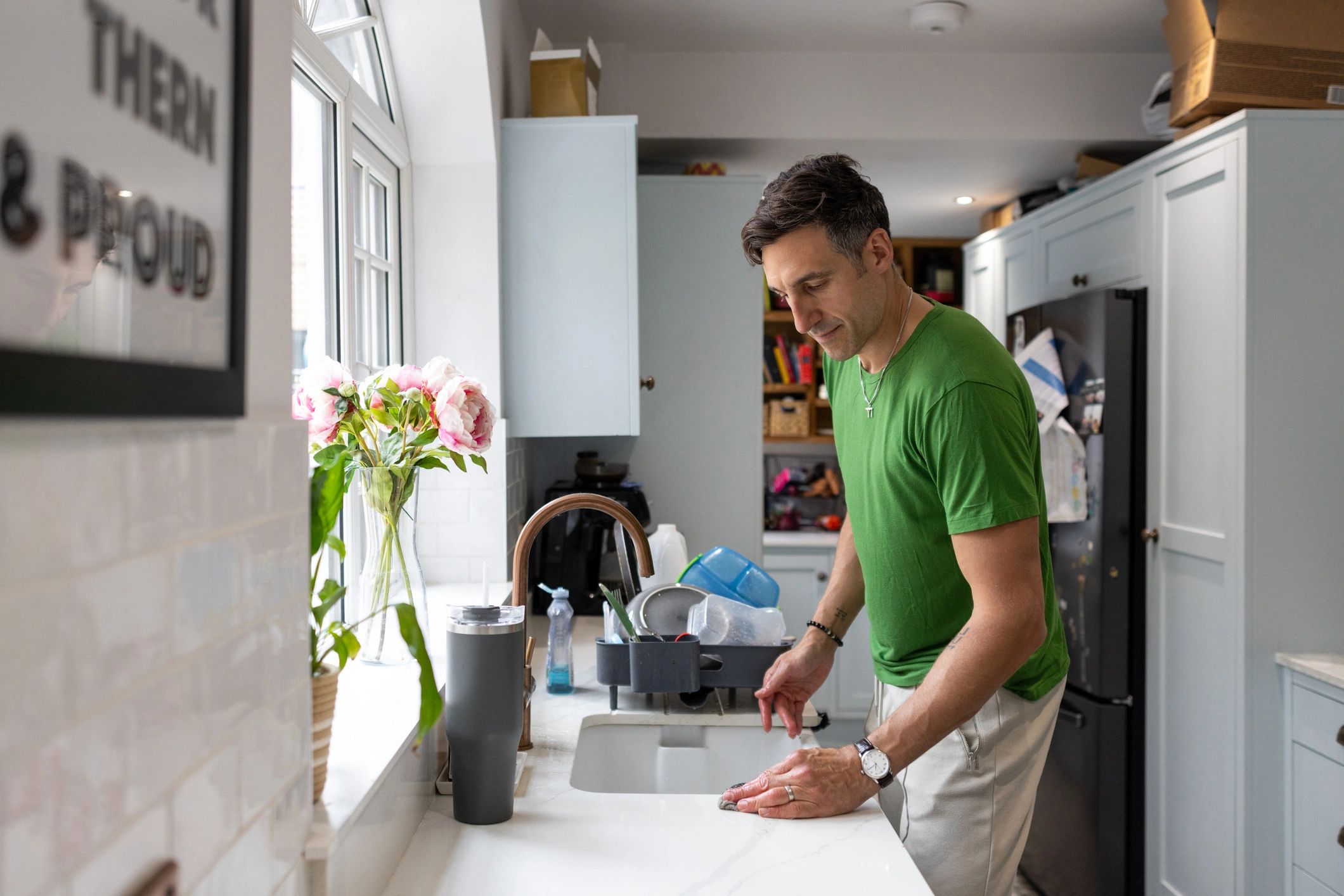 Professional cleaner maintaining a bright home kitchen